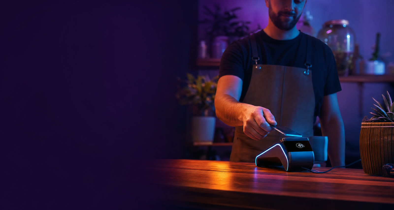 Customer tapping a card on a countertop payment terminal